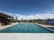 A large community pool on a sunny day with a clear blue sky and nearby recreation center with seating at 24285 E Wagon Trail Ave, Aurora, CO 80016