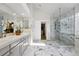 Bright bathroom with double vanity, glass enclosed shower with marble tile, and luxury finishes at 1361 Castlepoint Cir, Castle Pines, CO 80108