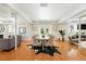 Bright dining room with a round table, stylish chairs, and a decorative rug on hardwood floors at 1361 Castlepoint Cir, Castle Pines, CO 80108