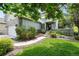 Charming home featuring a well-manicured lawn, stone accents and mature trees, creating curb appeal at 1361 Castlepoint Cir, Castle Pines, CO 80108