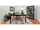 Bright home office with a dark wood desk, stylish shelving, and ample space for productivity at 1361 Castlepoint Cir, Castle Pines, CO 80108