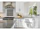 Updated kitchen featuring white cabinets, subway tile backsplash, stainless steel appliances, and natural light at 1361 Castlepoint Cir, Castle Pines, CO 80108