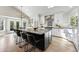 Eat-in kitchen featuring a large center island, stainless steel appliances, and bright white cabinetry at 1361 Castlepoint Cir, Castle Pines, CO 80108