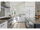 Modern kitchen showcasing stainless steel appliances, white cabinetry, and stylish tile backsplash at 1361 Castlepoint Cir, Castle Pines, CO 80108
