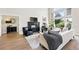 Bright living room featuring a fireplace, large windows with natural light, and hardwood floors at 1361 Castlepoint Cir, Castle Pines, CO 80108
