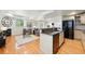 Open living space with hardwood floors, modern kitchen, fireplace, and comfortable seating area at 1361 Castlepoint Cir, Castle Pines, CO 80108