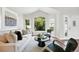 Bright living room with large windows, vaulted ceilings, and comfortable seating at 1361 Castlepoint Cir, Castle Pines, CO 80108