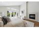 Serene main bedroom with a fireplace, plush seating, and access to a private balcony at 1361 Castlepoint Cir, Castle Pines, CO 80108