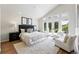 Spacious main bedroom with vaulted ceilings, plush seating, and access to a private balcony at 1361 Castlepoint Cir, Castle Pines, CO 80108