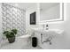 Chic powder room with modern fixtures, elegant wallpaper, unique accents and stylish design at 1361 Castlepoint Cir, Castle Pines, CO 80108