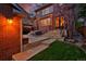 Charming backyard with brick patio, inviting seating, and well-manicured lawn, perfect for outdoor gatherings at 535 N High St, Denver, CO 80218