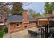 Picturesque backyard featuring a brick structure, outdoor fireplace, and an inviting patio area at 535 N High St, Denver, CO 80218