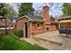 Well-maintained backyard with brick structure, outdoor fireplace, and comfortable seating area at 535 N High St, Denver, CO 80218