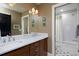 Well-designed bathroom with double vanity sinks, a neutral palette, and a shower/tub combo at 535 N High St, Denver, CO 80218