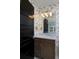 Stylish bathroom featuring a vanity with marble countertop, bird-themed wallpaper, and modern lighting at 535 N High St, Denver, CO 80218