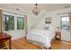 Sunlit bedroom with hardwood floors, complemented by modern furniture and an eye-catching light fixture at 535 N High St, Denver, CO 80218