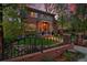 Charming two-story brick home with well-maintained landscaping and black iron fence at 535 N High St, Denver, CO 80218