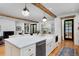 Bright kitchen featuring a large island, farmhouse sink, stainless steel appliances and hardwood floors at 535 N High St, Denver, CO 80218