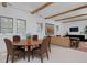 Open-concept living room with wood beams, dining area, and neutral decor, great for relaxing and entertaining at 535 N High St, Denver, CO 80218