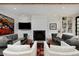 Comfortable living room with a fireplace, built-in shelving, and a large flat screen television at 535 N High St, Denver, CO 80218