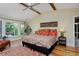 Spacious main bedroom with hardwood floors, ceiling fan and light-filled windows offering scenic views at 535 N High St, Denver, CO 80218
