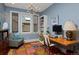 Bright home office with ample natural light, custom desk, and colorful rug, perfect for productivity at 535 N High St, Denver, CO 80218