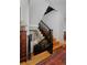 Elegant staircase with dark wood railings and light wood steps, complemented by a decorative cabinet at 535 N High St, Denver, CO 80218