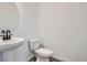 Modern powder room featuring a pedestal sink and a minimalist design at 9645 Browns Peak Cir, Littleton, CO 80125
