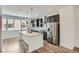 Stylish kitchen featuring a center island, stainless steel appliances, and modern pendant lighting at 9645 Browns Peak Cir, Littleton, CO 80125