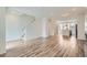 Bright living space with wood-look floors, an adjacent kitchen, and stairs leading to the upper level at 9645 Browns Peak Cir, Littleton, CO 80125