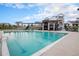 Exterior view of a large community swimming pool with a modern clubhouse and ample seating at 9645 Browns Peak Cir, Littleton, CO 80125