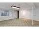 Spacious basement featuring neutral carpet, white walls, and a bright window, great for recreation or storage at 1847 S Union Blvd, Lakewood, CO 80228
