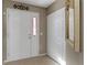 Welcoming entryway has a storage closet, a glass-paneled door, and neutral tile flooring at 1847 S Union Blvd, Lakewood, CO 80228