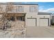 Two-story home with neutral siding, a two-car garage, and a stone accent front porch area at 1847 S Union Blvd, Lakewood, CO 80228