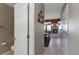 Hallway leading to the dining area and living room featuring neutral walls and tile floors at 1847 S Union Blvd, Lakewood, CO 80228