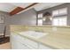 Bright kitchen features white cabinets, a dual basin sink, and contemporary countertops at 1847 S Union Blvd, Lakewood, CO 80228