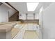Bright kitchen featuring white cabinetry, wooden countertops, and modern appliances at 1847 S Union Blvd, Lakewood, CO 80228
