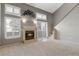 Bright living room with a cozy fireplace, neutral carpet, many windows, and access to the upper floors at 1847 S Union Blvd, Lakewood, CO 80228