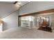 Spacious living space that connects kitchen and dining areas, complemented by neutral tones and wood accents at 1847 S Union Blvd, Lakewood, CO 80228