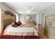 This stylish main bedroom features natural light and a wooden dresser with a round mirror at 1847 S Union Blvd, Lakewood, CO 80228