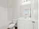 Clean bathroom with white fixtures, a shower-tub combo, and a modern vanity at 8809 Sedalia St, Commerce City, CO 80022