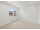 Bright, carpeted bedroom with neutral walls and a large window at 8809 Sedalia St, Commerce City, CO 80022