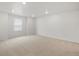 A spacious bedroom features plush carpeting, recessed lighting, and a large window for ample natural light at 8809 Sedalia St, Commerce City, CO 80022
