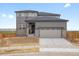 Charming two-story home with a two-car garage, stone accents, and gray siding at 8809 Sedalia St, Commerce City, CO 80022