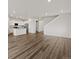 Bright, open-concept living space with modern kitchen and light wood floors at 8809 Sedalia St, Commerce City, CO 80022