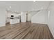 Bright, open-concept living space with modern kitchen and light wood floors at 8809 Sedalia St, Commerce City, CO 80022