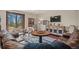 Basement lounge area with leather couches and a rustic cabinet at 28940 Pinewood Vista Dr, Evergreen, CO 80439