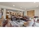 Spacious basement recreation room, featuring a large leather sectional sofa and a wet bar at 28940 Pinewood Vista Dr, Evergreen, CO 80439