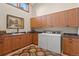 Convenient laundry room with washer, dryer and ample cabinet space at 28940 Pinewood Vista Dr, Evergreen, CO 80439