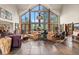 Open living room with stone fireplace, high ceilings and abundant natural light at 28940 Pinewood Vista Dr, Evergreen, CO 80439